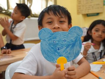 Student showing his picture at drawing class